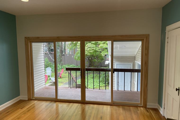 A new patio door and railing seen from the finished room