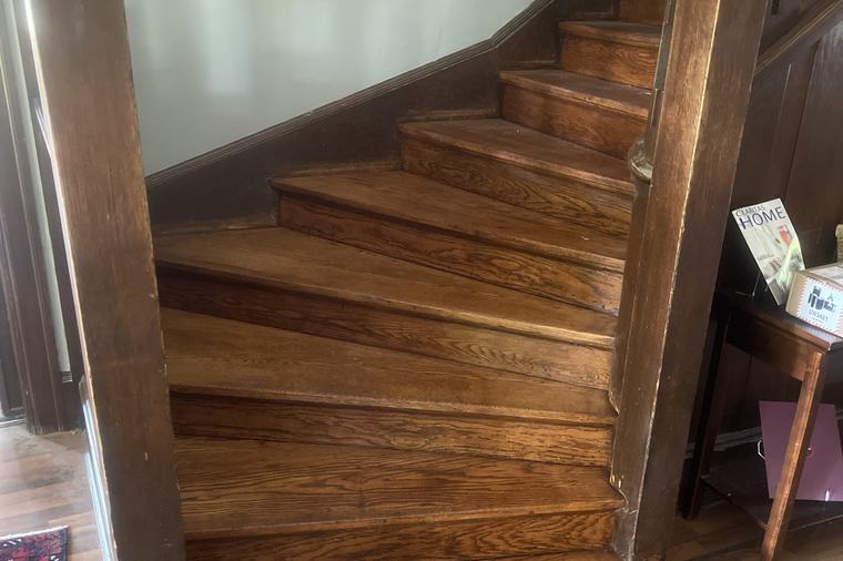 A refinished staircase in a finished hallway