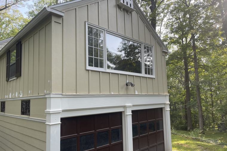 A finished exterior with new siding, trim and crisp paint lines