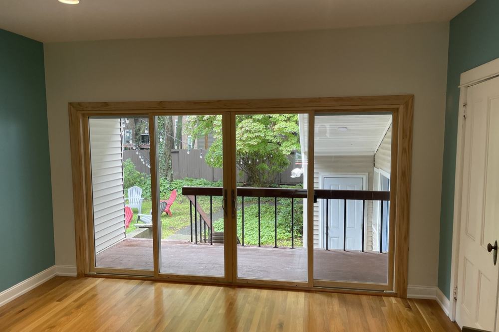 A new patio door and railing seen from the finished room