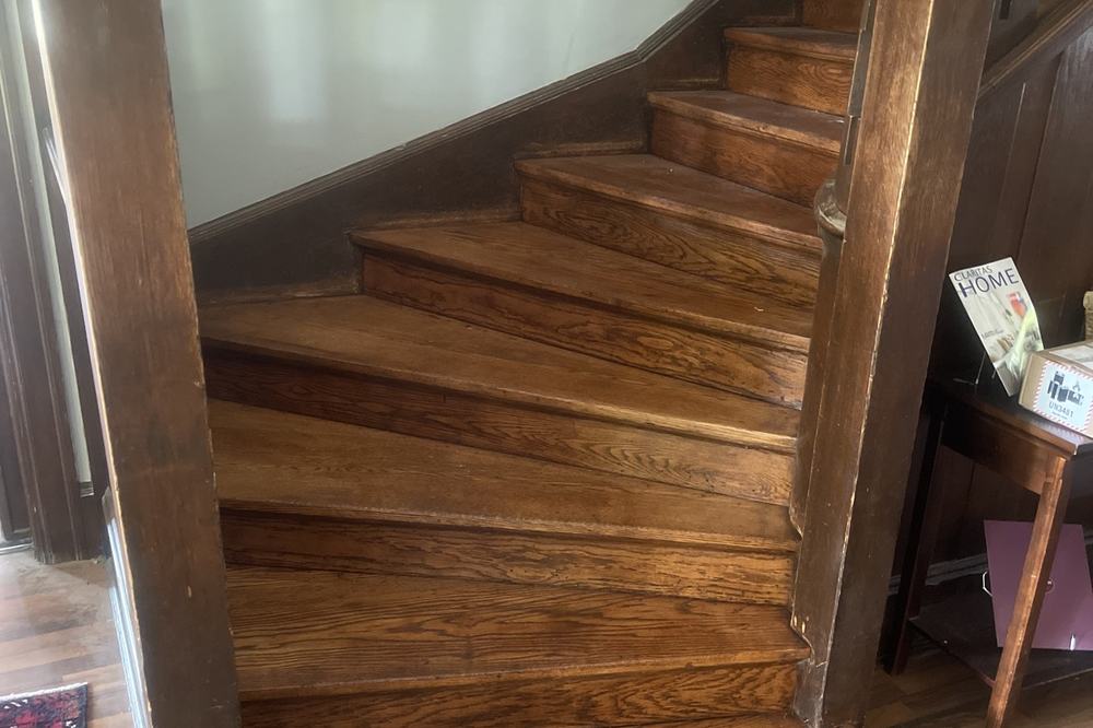 A refinished staircase in a finished hallway